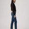 sideview of model wearing dark wash wedgie straight jeans