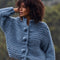 side view of model wearing dusky blue oversized knit cardigan with oversized buttons