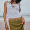 up close of model wearing olive crinkle midi skirt with shaped shell buttons on the top