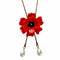 up close of red poppy bolo with bronze chain and pearl dangles