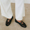 model wearing black open woven ballet flats with strap and buckle