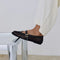 side view of model wearing black open woven ballet flats with strap and buckle