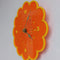side view of orange retro floral clock with yellow trim