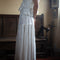 side view of model wearing white asymmetric maxi skirt with lace and embroidery detail