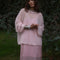 model wearing sheer pink oversized sweater over a pink midi dress