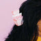 model wearing pink and white stacked 'pyrex' bowl inspired hair claw