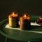 sweet scented candles on a green table
