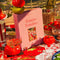 boxed 'tomato tomahto' 1000 piece puzzle with various tomato items on a red tiled table surrounded by tomato items