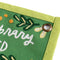 up close of rectangular banner with green trim and embroidered 'if you have a garden and a library you have everything you need' across the front