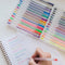 model writing with set of 30 glitter, metallic, pastel, neon and primary gel pens