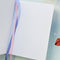 interior pages of trinket themed journal with light pink elastic and purple and pink satin ribbons for a placeholder