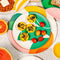 cream salad plate with abstract palm leaf print with foods on it
