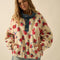 model wearing white sherpa half zip with denim trim and collar and red floral print
