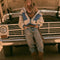 model wearing cream sherpa zip-up jacket with blue denim trim with a high neck collar standing in front of a truck
