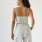 model showing smocked back of pastel wavy print bustier tank and matching bottoms