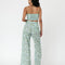 back view of model wearing mint wide leg pants with dainty blueberry vine print and matching cropped tank