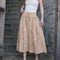 model wearing smocked top midi skirt with all over embroidered daisy print