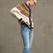 side view of model wearing cream toggle front cardigan with brown, yellow, navy, and raspberry nordic pattern