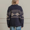 back view of model wearing navy oversized collared cardigan with white snowflake print and patch pockets