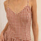 up close of model wearing brown and white gingham cotton midi dress with spaghetti straps and drop waist