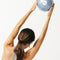 model using light blue/gray pilates ball