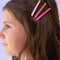 model wearing set of three acetate bobby pins with light pink, hot pink and coral colorways