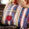 sideview of orange, dark blue and light blue plaid recycled plastic tote with ribbon detail and tomato applique