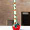 tomato shaped candle holder with a mint taper candle inside