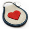 side view of cream patch keychain with red heart and navy trim