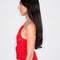 side view of model wearing red knit halter top with white flower print on the front