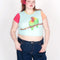 model wearing light blue relaxed baby tee with one red and one orange sleeve and realistic parrot print on the front