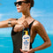 model holding 20 fl oz vacation classic lotion with removable rubber strap handle