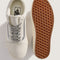 top and bottom view of white pair of sneakers with silver metallic laces and iconic stripe
