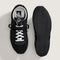 top and bottom view of black vans super low pro trainer sneakers with white laces