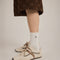model wearing vans super low pro with brown, beige and cream with brown wraparound laces