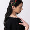 model wearing set of two long stemmed rose barrettes