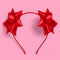 two red bows on the side of a headband