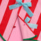 button closure of pink and red stripe tree skirt with three baby blue bows down the front and kelly green trim