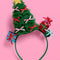 green tulle christmas tree with colorful bows, gold star and stacked christmas presents