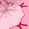 light pink tree skirt with red velvet bows and red scalloped trim