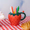 12 oz. strawberry ceramic mug with 3D snail on the handle with pencils inside