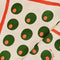up close of cream tea towel with all over olive print and red border