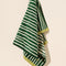 hanging green and cream vertical stripe terry cloth towel with lime green trim