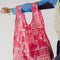 model holding standard baggu with hot pink ground and all over print