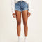 model wearing high rise raw hem denim shorts
