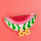editorial image of abstract watermelon trinket tray, yellow floral earrings on a orange background