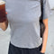 model wearing heather grey tee