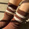 up close of model wearing brown socks with two white stripe cuff