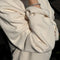up close of model wearing naturel relaxed fit raglan sweatshirt tunic