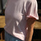 model wearing baby pink tee